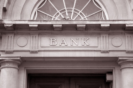 38373640 - bank sign over entrance door in black and white sepia tone